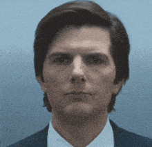 a close up of a man 's face in a suit and tie