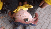 a stuffed animal with a yellow scarf around it 's neck