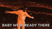 a man in yellow pants is dancing with the words baby we already there above him