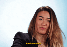 a woman in a black jacket says manicure time in yellow letters