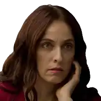 a close up of a woman 's face with her hand to her face