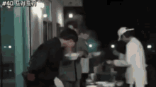 a group of people are standing around a table with a sign that says # 40 on it
