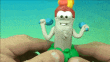 a person is holding a toy that looks like a worm with dumbbells in his hands .
