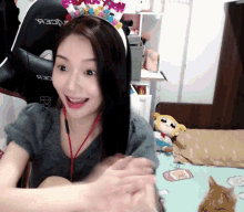 a woman wearing a headband with a crown on it is smiling