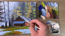 a person is painting a house in the woods with a brush