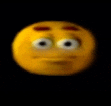a close up of a yellow smiley face on a black background .