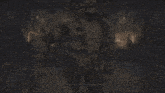 a monster is standing on a grid floor in a dark room .