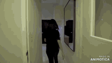 a woman walking down a hallway with the words made in animotica on the bottom