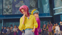 a couple of cartoon characters standing in front of a crowd with netflix written on the bottom