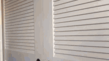 a person 's hand is sticking out of a doorway