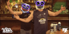two men wearing shirts that say fight hulk are standing in front of a bar