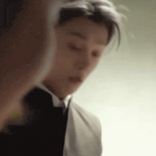 a man in a suit and tie is taking a selfie .