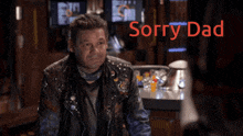 a man with dreadlocks is standing in front of a sign that says " sorry dad "