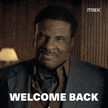 a man in a suit says welcome back