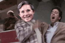 a man in a suit is being held by another man