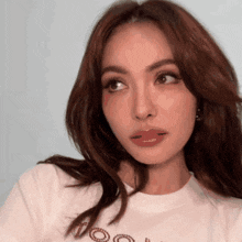 a woman wearing a white t-shirt that says too on it