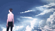 a man without a shirt is standing in the clouds