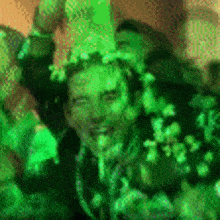 a man is covered in green slime while standing in a crowd of people .