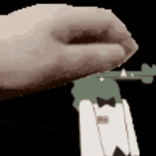 a close up of a person 's hand holding a gun with a cartoon character in the background .