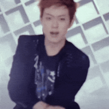 a blurry photo of a young man in a black jacket