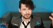 a man with curly hair and a beard wears a jacket that says rk800 on it
