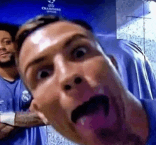a man is sticking his tongue out while standing next to another man .