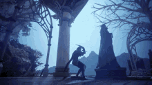 a statue of a man with a sword is standing in front of a building