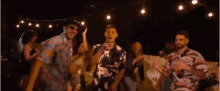 a group of people are dancing at a party at night