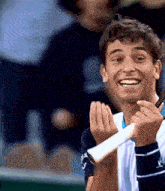 a man holding a tennis racquet and smiling
