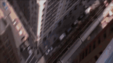 an aerial view of a city with a train going down it