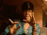 a man wearing a hat is smoking a cigarette with his eyes closed