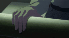 a close up of a person 's hand on a railing in a dark room