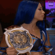a woman with blue hair is holding a diva title belt