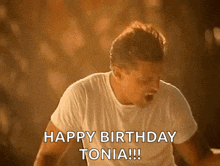 a man in a white shirt is shouting happy birthday tonia !!