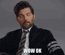 a man in a suit and tie with wow ok written below him