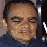 a close up of a man 's face with a straw in his mouth .