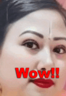 a close up of a woman 's face with the word wow written in red