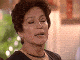 a close up of a woman 's face with her eyes closed and her mouth open