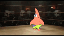 patrick star is standing in a boxing ring with a crowd behind him
