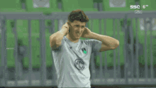 a man in a soccer uniform with the letter g on his chest
