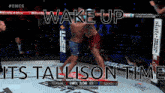 two men are fighting in a boxing ring with the words wake up its tallison time