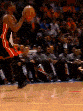 a basketball player is jumping in the air while holding a ball