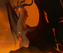 a drawing of a dragon with horns and wings in a dark room