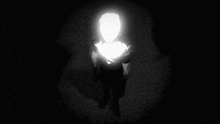 a person is standing in the dark with a light shining on their face