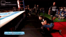 a wrestling match is being broadcasted on a tv channel