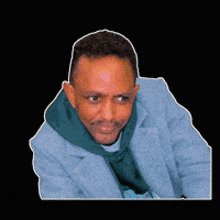 a man wearing a blue jacket and a green hoodie with the word king behind him