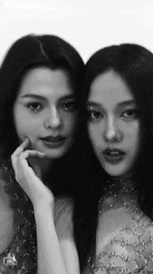 two women are standing next to each other and one has rhinestones on her nose