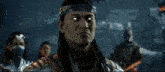 a man with long hair is standing next to another man in armor