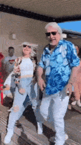 a man and a woman are dancing on a porch .