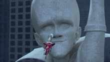 a statue of a man with a woman sticking out of it 's mouth